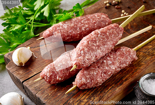 Image of fresh raw minced meat skewers kebabs