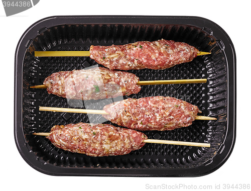 Image of fresh raw minced meat skewers in plastic box