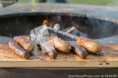 Image of Grilling sausages on barbecue grill