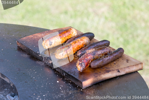 Image of Grilling sausages on barbecue grill