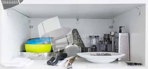 Image of Various tableware on shelf in the kitchen