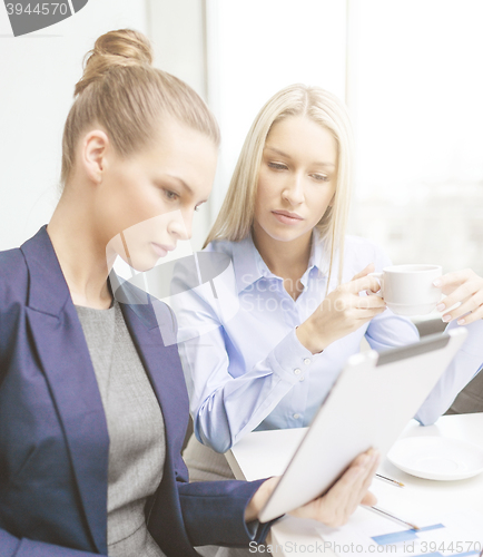 Image of business team with tablet pc having discussion