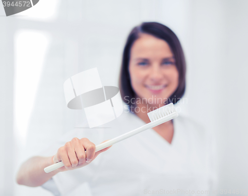 Image of dentist with toothbrush in hospital