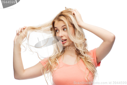 Image of woman holding strand of her hair