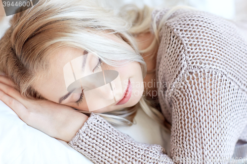 Image of woman or teenage girl sleeping on pillow at home