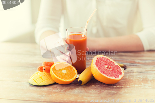 Image of close up of woman hands with juice and fruits