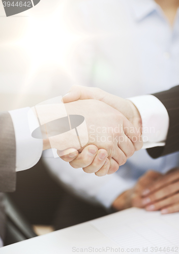 Image of two businessmen shaking hands in office