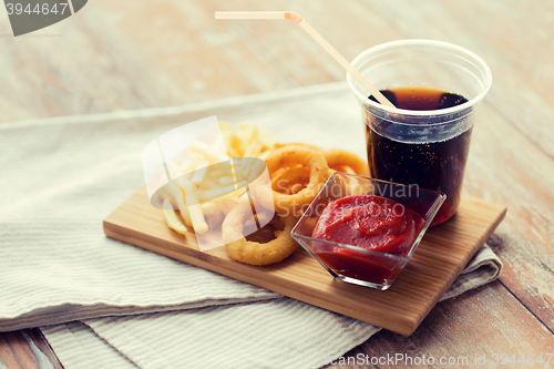 Image of close up of fast food snacks and drink on table