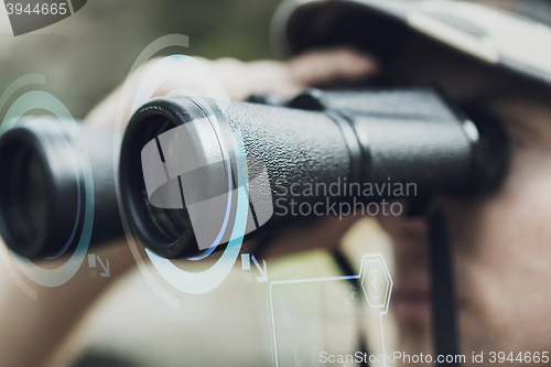 Image of close up of soldier or hunter with binocular