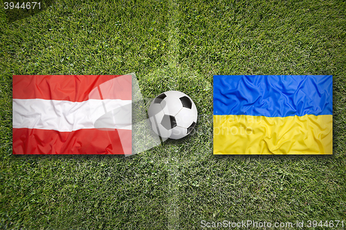 Image of Austria vs. Ukraine flags on soccer field