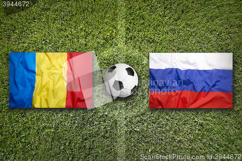 Image of Romania vs. Russia flags on soccer field