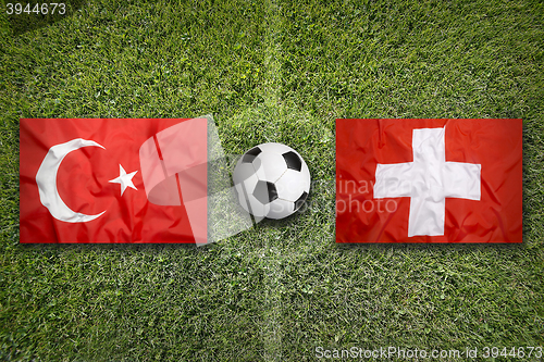 Image of Turkey vs. Switzerland flags on soccer field