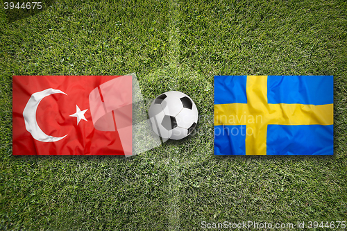 Image of Turkey vs. Sweden flags on soccer field