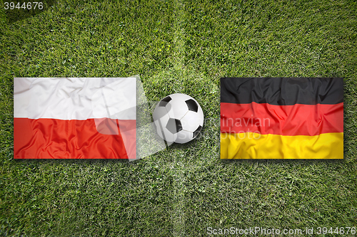 Image of Poland vs. Germany flags on soccer field