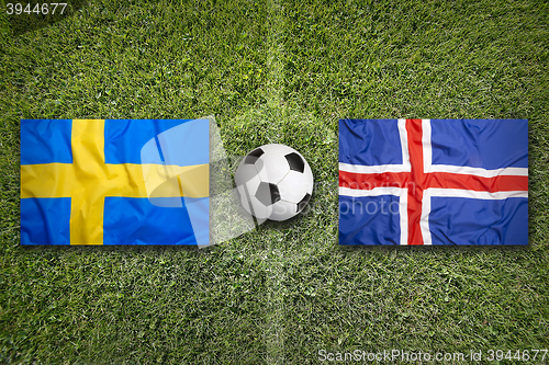 Image of Sweden vs. Iceland flags on soccer field