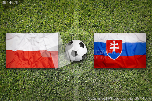 Image of Poland vs. Slovakia flags on soccer field