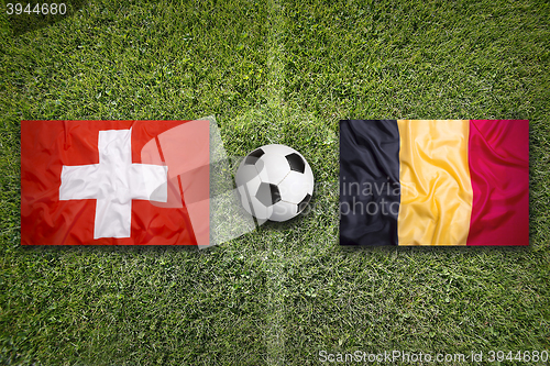 Image of Switzerland vs. Belgium flags on soccer field