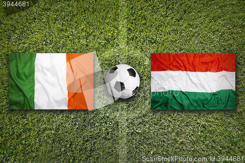 Image of Ireland vs. Hungary flags on soccer field