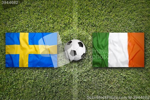 Image of Sweden vs. Ireland flags on soccer field