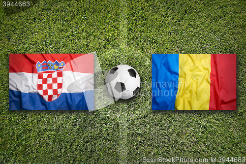 Image of Croatia vs. Romania flags on soccer field