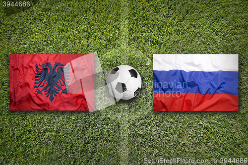 Image of Albania vs. Russia flags on soccer field