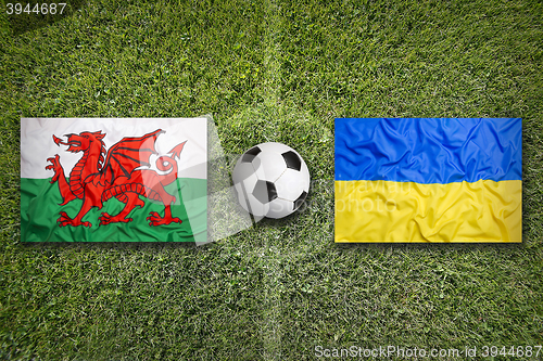 Image of Wales vs. Ukraine flags on soccer field