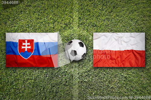 Image of Slovakia vs. Poland flags on soccer field