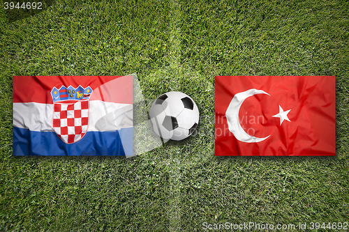 Image of Croatia vs. Turkey flags on soccer field