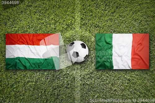 Image of Hungary vs. Italy flags on soccer field