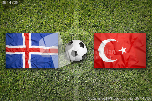 Image of Iceland vs. Turkey flags on soccer field