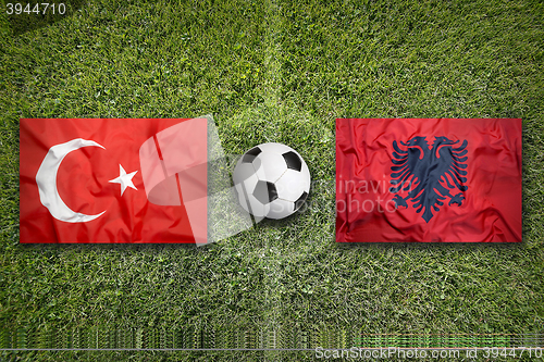 Image of Turkey vs. Albania flags on soccer field