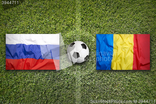 Image of Russia vs. Romania flags on soccer field