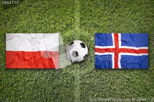 Image of Poland vs. Iceland flags on soccer field