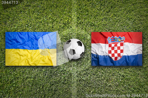 Image of Ukraine vs. Croatia flags on soccer field