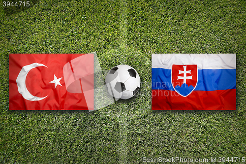 Image of Turkey vs. Slovakia flags on soccer field