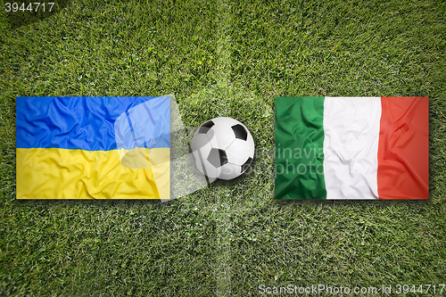 Image of Ukraine vs. Italia flags on soccer field