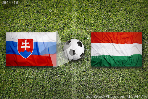 Image of Slovakia vs. Hungary flags on soccer field