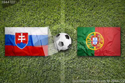 Image of Slovakia vs. Portugal flags on soccer field