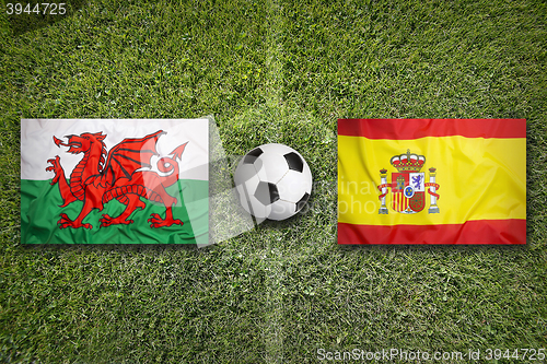 Image of Wales vs. Spain flags on soccer field