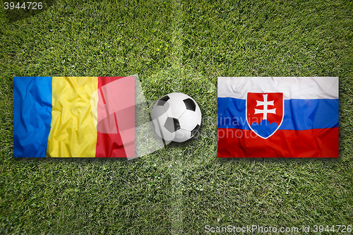 Image of Romania vs. Slovakia flags on soccer field