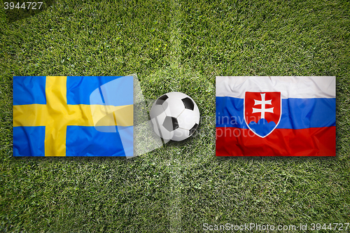 Image of Sweden vs. Slovakia flags on soccer field