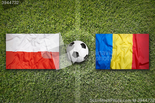Image of Poland vs. Romania flags on soccer field