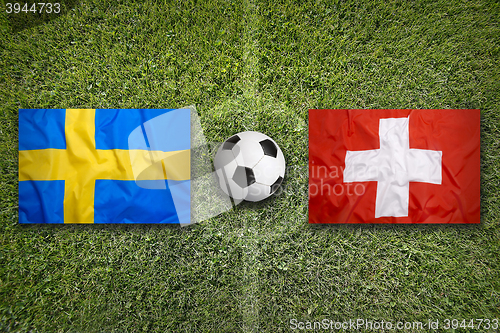 Image of Sweden vs. Switzerland flags on soccer field