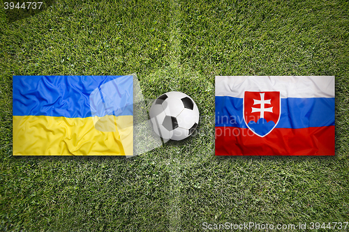 Image of Ukraine vs. Slovakia flags on soccer field