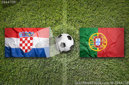 Image of Croatia vs. Portugal flags on soccer field