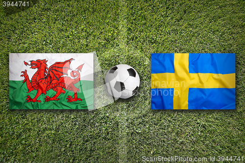 Image of Wales vs. Sweden flags on soccer field