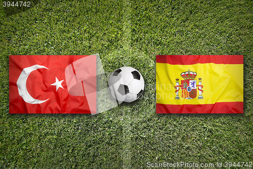 Image of Turkey vs. Spain flags on soccer field