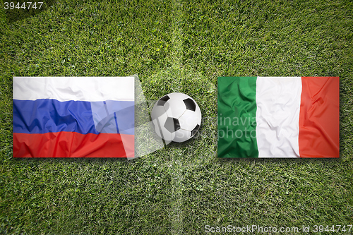 Image of Russia vs. Italy flags on soccer field
