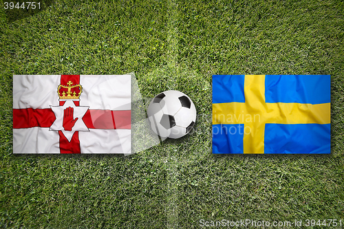 Image of Northern Ireland vs. Sweden flags on soccer field