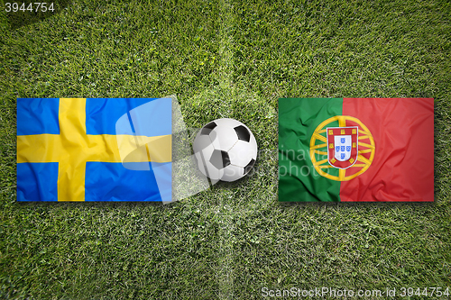 Image of Sweden vs. Portugal flags on soccer field